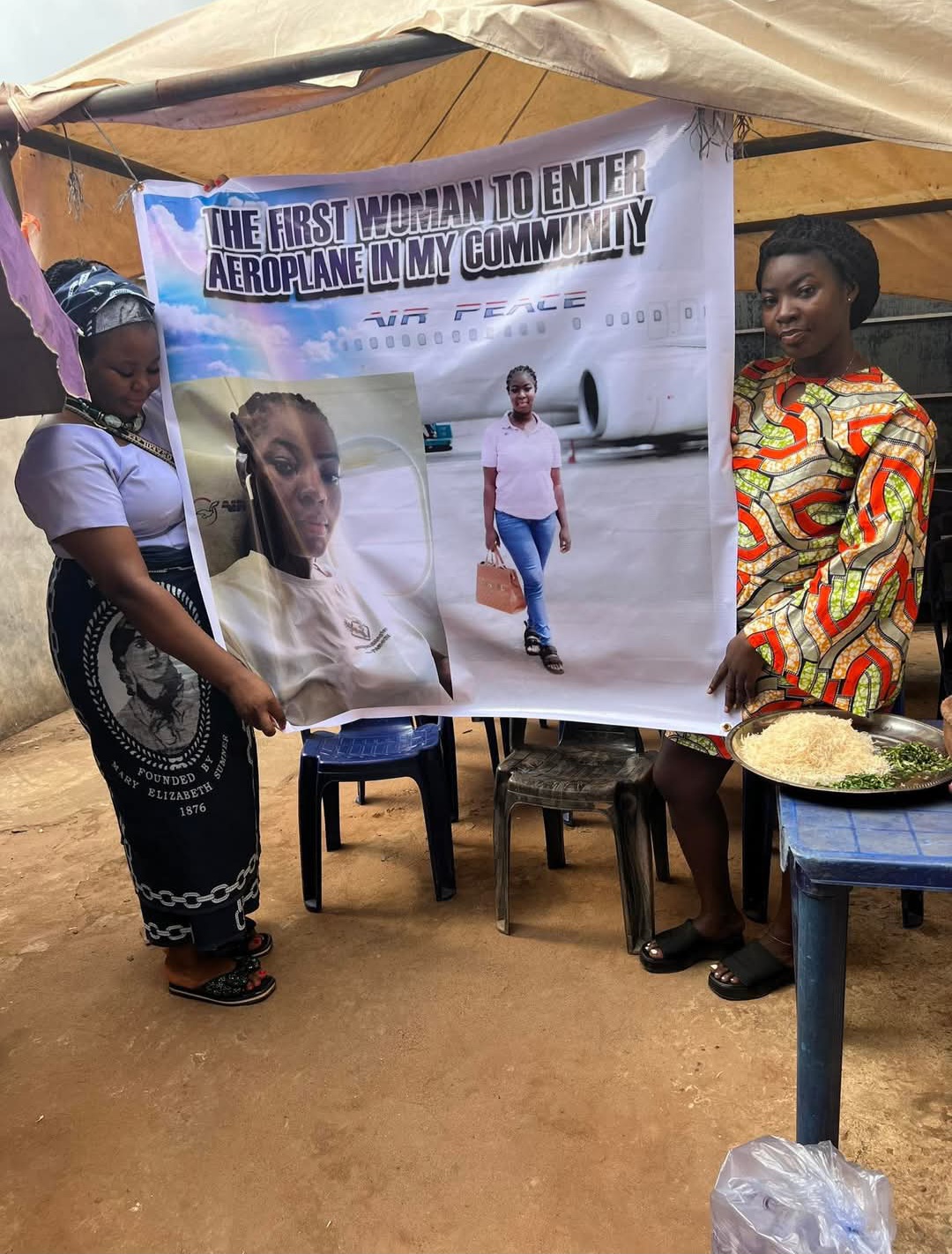 Woman prints banner and calls her community to celebrate with her on becoming the "first woman to enter airplane" in her community