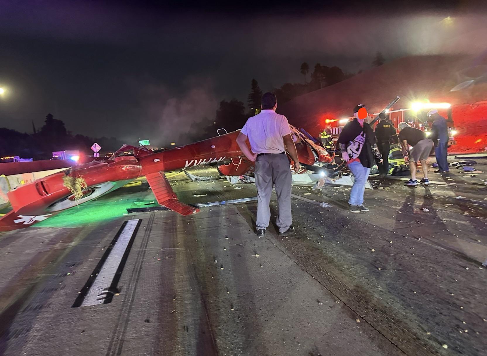Three people critically injured after medical helicopter crashes onto road (video)