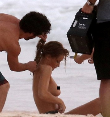 Rosie Huntington-Whiteley poses topless on beach in Bahamas as she flaunts trim figure six months after welcoming baby