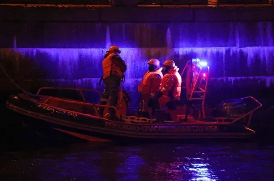 Professor arrested on suspicion of murder after he was dragged from a river with severed arms of his student in his bag