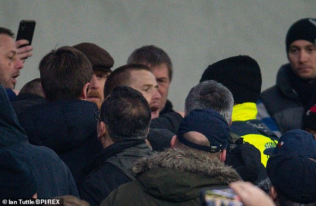 Unbelievable moment Tottenham player Eric Dier jumps into crowd to fight fan for insulting him after club crash out of FA Cup (photos/video)