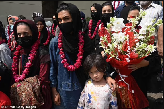Afghanistan?s girl?s football teams flee across the border to Pakistan wearing burqas 