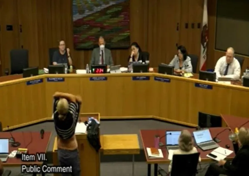 Shocking moment mum strips during school board meeting to protest transgender�students using girls