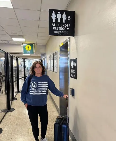 Shocking moment mum strips during school board meeting to protest transgender�students using girls